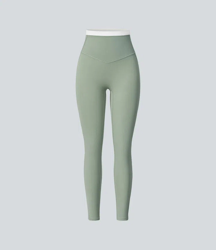 Halara UltraSculpt dopasowane legginsy do jogi z wysokim stanem, efektem modelującym brzuch, w designie color block i kieszeniami.