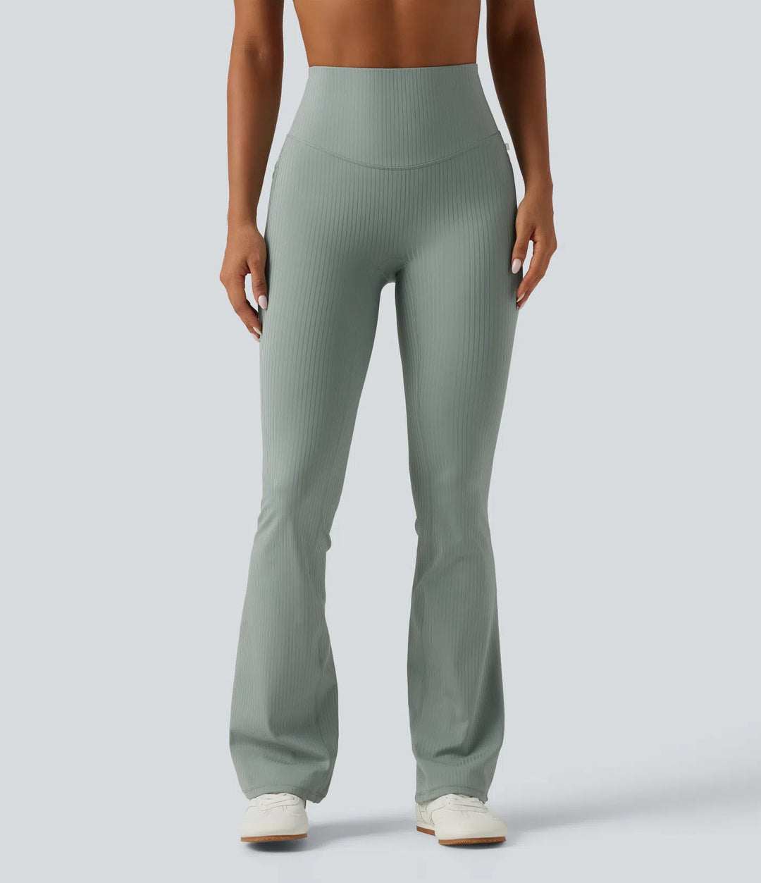 Prążkowane dzianinowe legginsy o kroju bootcut z wysokim stanem, modelującym efektem w talii i brzuchu oraz kieszeniami